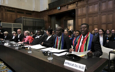 Ambassador of the Republic of South Africa to the Netherlands Vusimuzi Madonsela, right, and Minister of Justice and Correctional Services of South Africa Ronald Lamola, center, during the opening of the hearings at the International Court of Justice in The Hague, Netherlands, Thursday, Jan. 11, 2024. (AP Photo/Patrick Post)